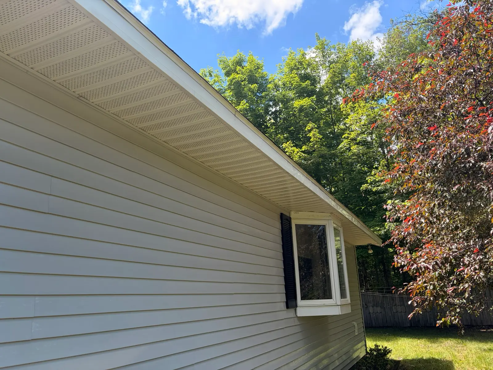 The same soffit and fascia cleaned back to bright white after a soft wash