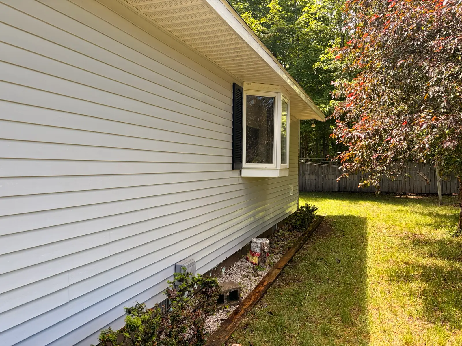 The same bay-window wall cleaned bright and even after a soft wash